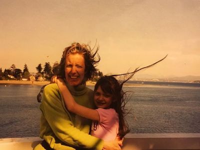 Colby and Kemp Minifie are hugging each other and there is a sea in the background.